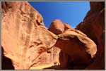 Visitors thru Sandstone Arch.