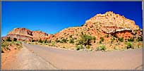 Towering walls by the road panorama.