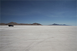 A Car Roars Across The Salt Flats