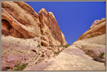 A couple walks out of the White Domes trail